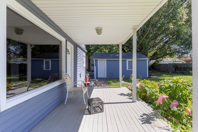 deck with a yard and an outbuilding