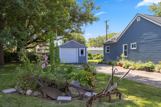 view of yard featuring a garage and an outbuilding