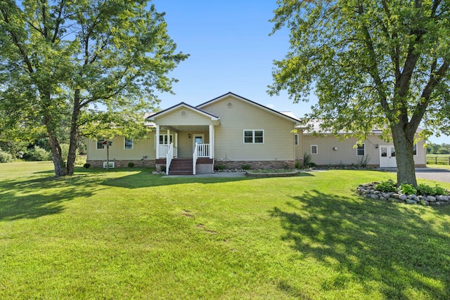 view of front of home with a front yard and covered porch