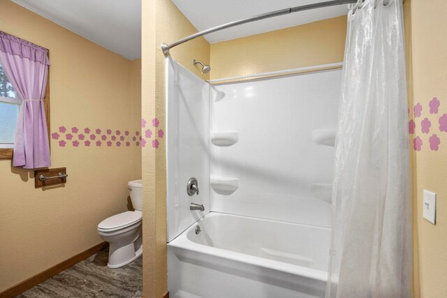 bathroom with toilet and shower / bath combination with curtain