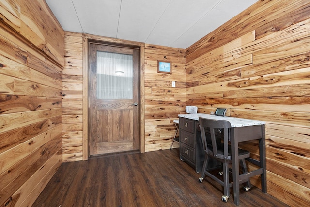 unfurnished office with wooden walls and dark hardwood / wood-style floors