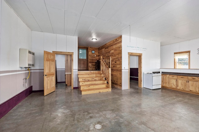 kitchen featuring wood walls and white gas range oven