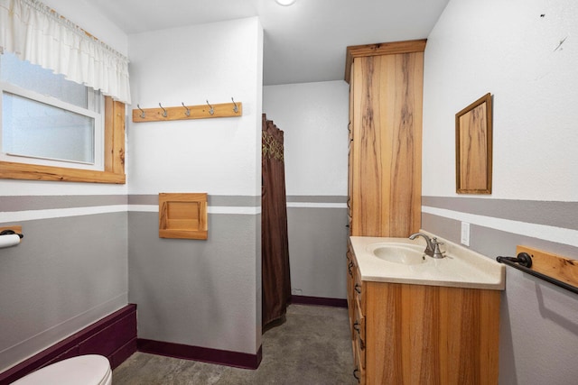 bathroom with toilet and vanity