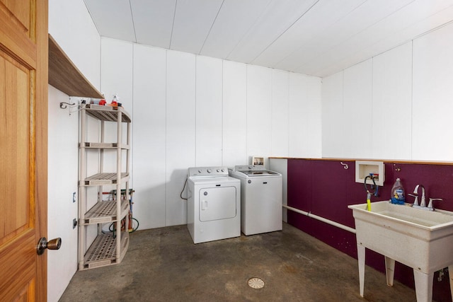 clothes washing area featuring sink and washing machine and dryer