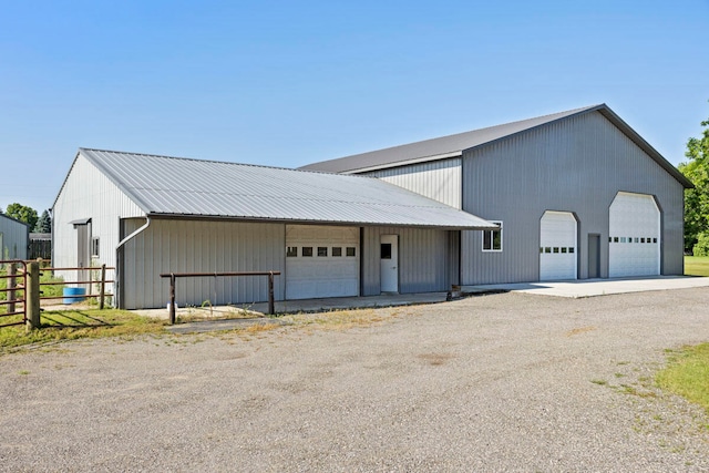 view of front of house featuring a garage and an outdoor structure