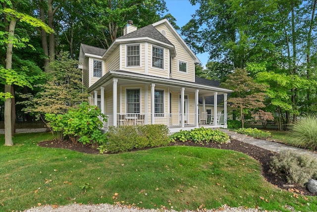 view of front of home with a front lawn and a porch