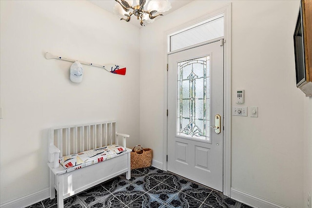 tiled foyer entrance with a notable chandelier