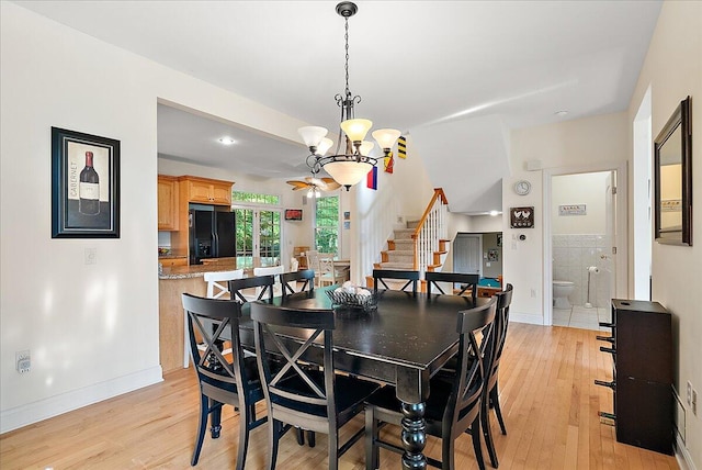 dining area featuring light hardwood / wood-style flooring and a chandelier