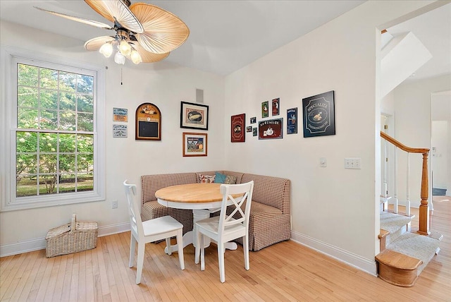 dining area with light wood-type flooring and ceiling fan