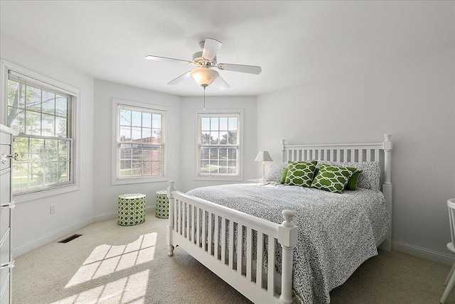 bedroom with ceiling fan and light carpet