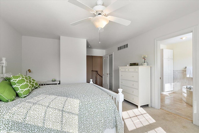 bedroom with ceiling fan and light carpet