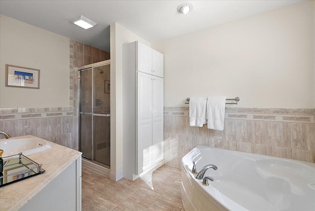 bathroom with separate shower and tub and tile patterned flooring