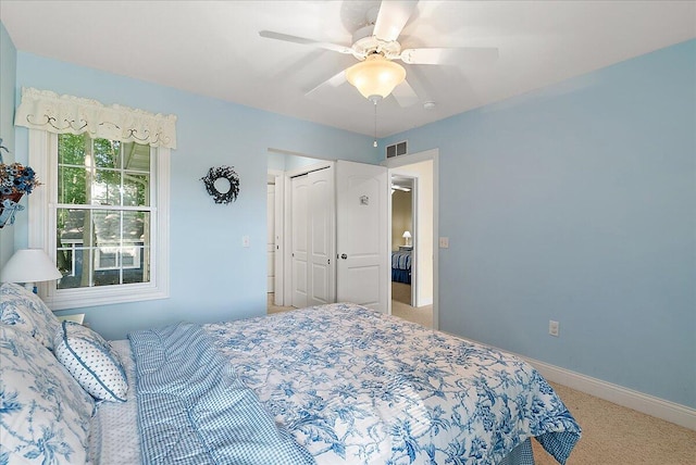 carpeted bedroom with ceiling fan and a closet