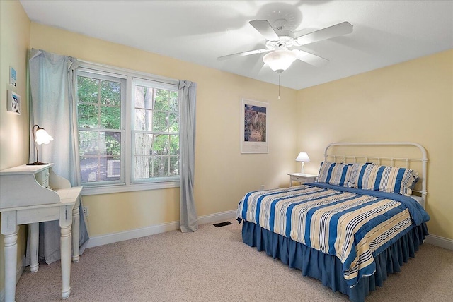 bedroom featuring ceiling fan and light carpet