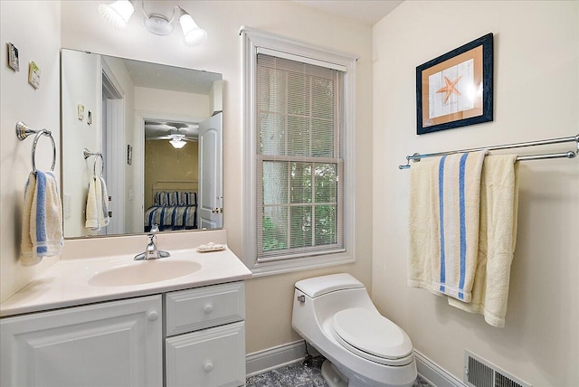 bathroom featuring vanity, toilet, and ceiling fan