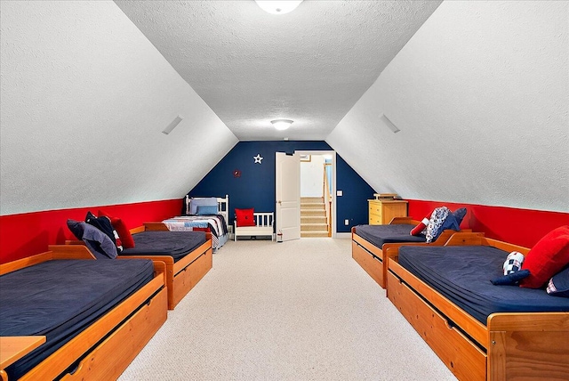 carpeted bedroom featuring lofted ceiling and a textured ceiling