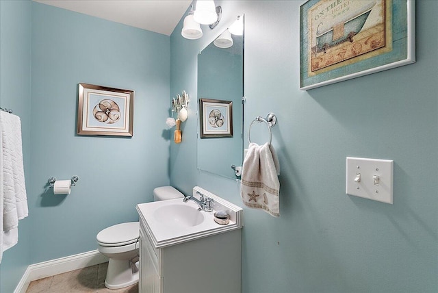 bathroom featuring tile patterned flooring, vanity, and toilet