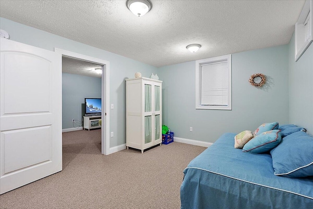 bedroom with a textured ceiling and carpet floors