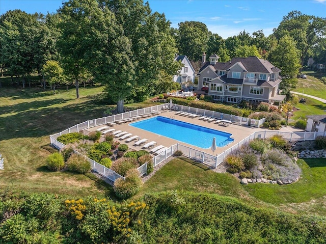 view of pool with a lawn