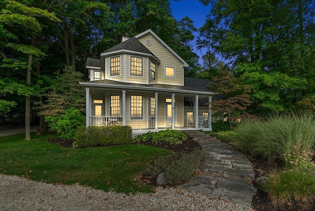 view of front of home with a lawn and covered porch