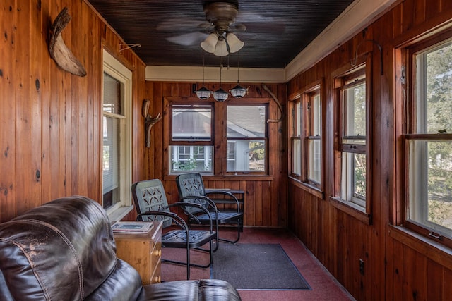 sunroom featuring ceiling fan and a healthy amount of sunlight