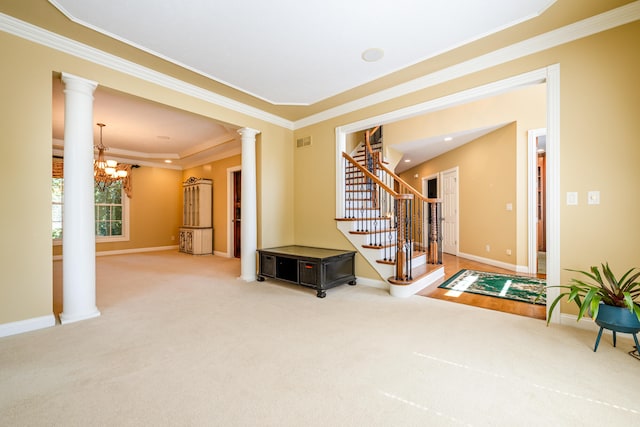 interior space featuring crown molding, ornate columns, an inviting chandelier, and carpet flooring