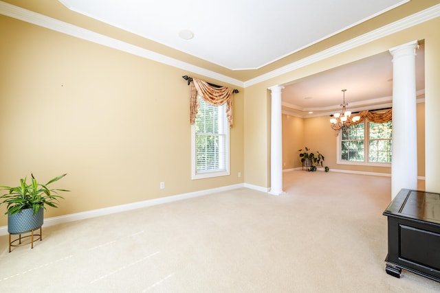 interior space featuring ornamental molding, a chandelier, and ornate columns