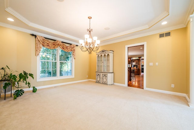 empty room with crown molding, carpet flooring, and a notable chandelier