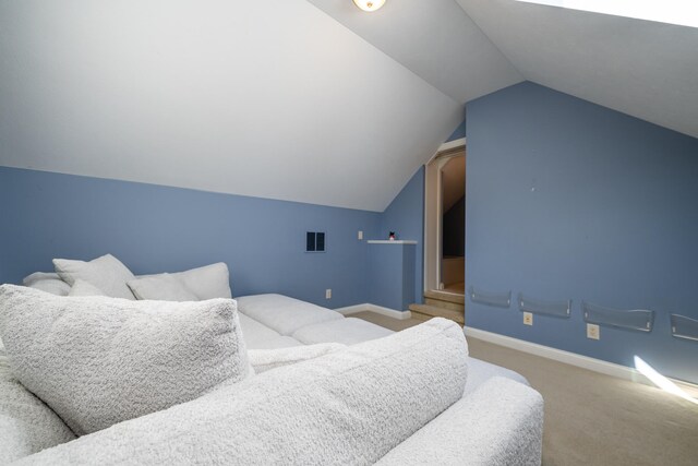 bedroom featuring lofted ceiling and carpet