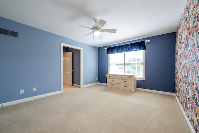 unfurnished bedroom featuring ceiling fan and light carpet