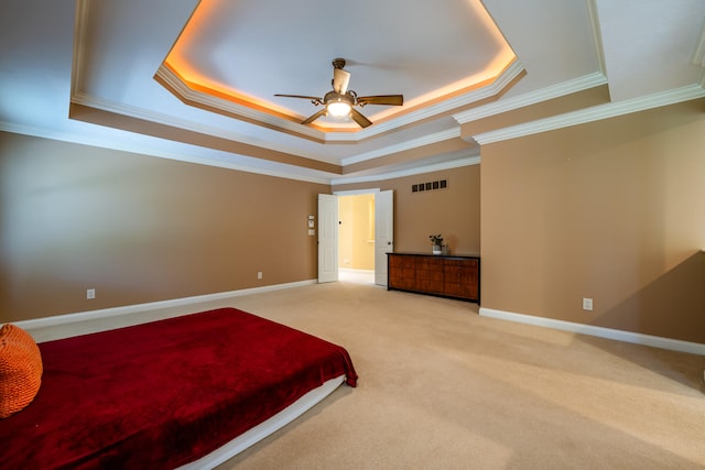 bedroom featuring crown molding, ceiling fan, and a tray ceiling