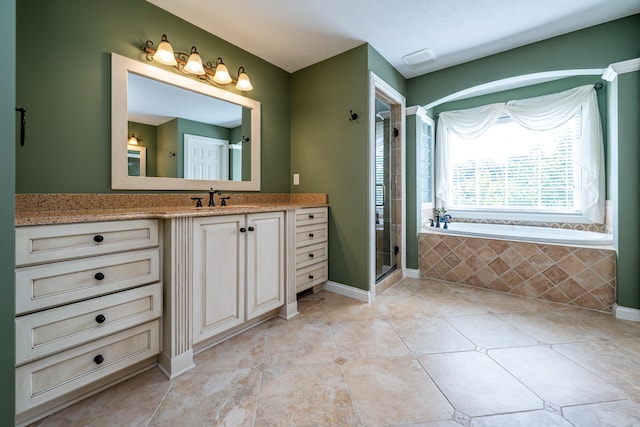 bathroom with tile patterned floors, independent shower and bath, and vanity