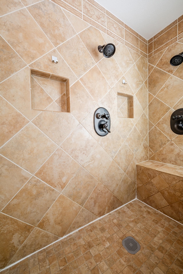 bathroom with tiled shower