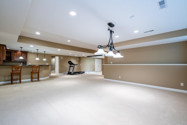 unfurnished living room with bar area and light colored carpet