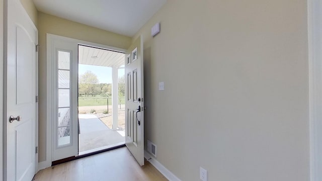 doorway to outside with light wood-type flooring