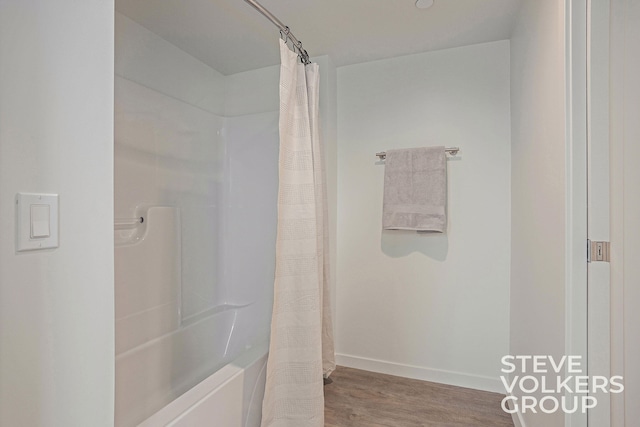 bathroom featuring shower / bath combo and hardwood / wood-style flooring