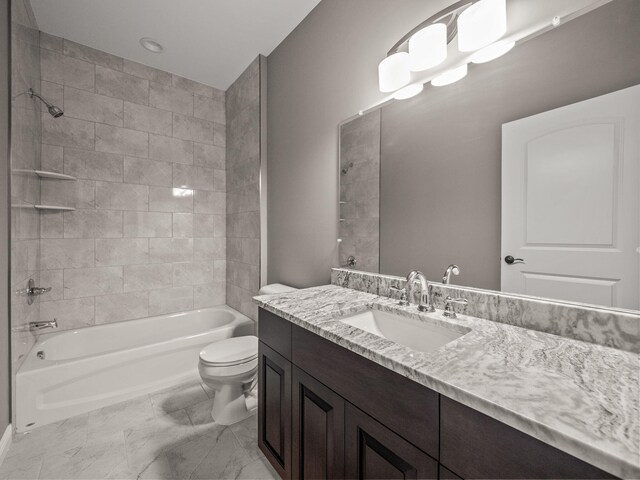 full bathroom featuring tiled shower / bath, toilet, and vanity