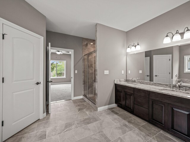 bathroom featuring ceiling fan, a shower with door, and vanity