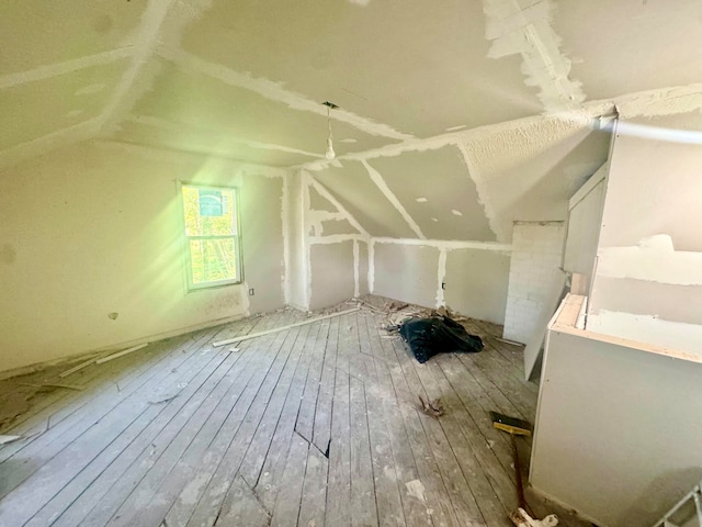 bonus room featuring lofted ceiling and hardwood / wood-style floors