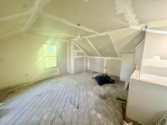 additional living space with lofted ceiling and wood-type flooring