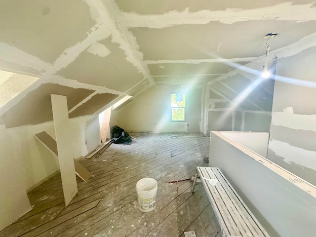 additional living space featuring lofted ceiling and wood-type flooring