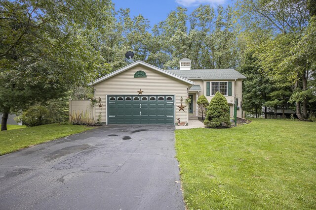 view of front of property with a front yard and a garage