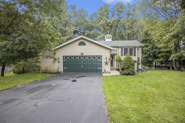 view of front of house with a garage, driveway, and a front lawn