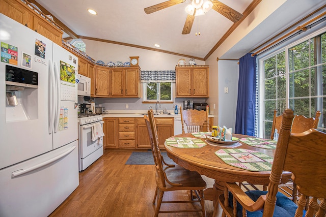 kitchen featuring white appliances, ornamental molding, lofted ceiling, ceiling fan, and light wood-type flooring