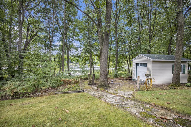 view of yard with a garage and an outdoor structure