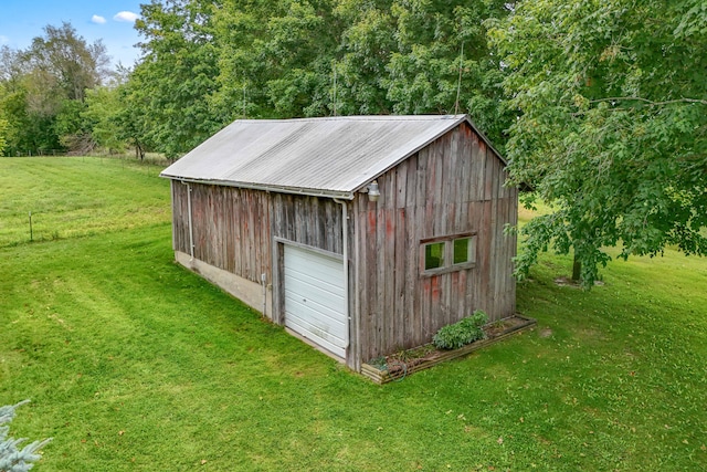 view of outdoor structure with a lawn and a garage