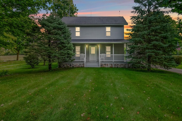 view of front of property featuring a yard and a porch