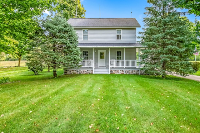 back of house featuring covered porch and a lawn