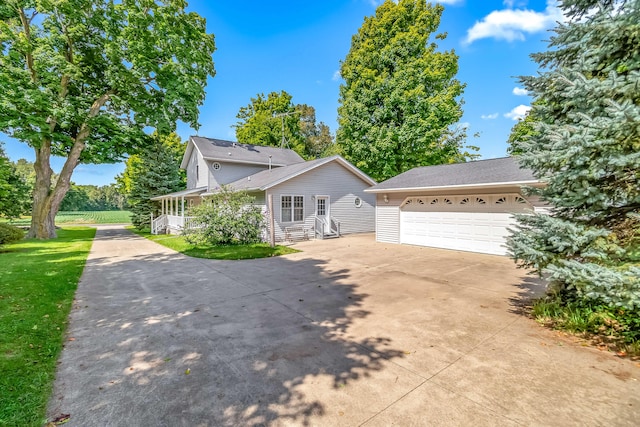 front facade with a garage and a front lawn