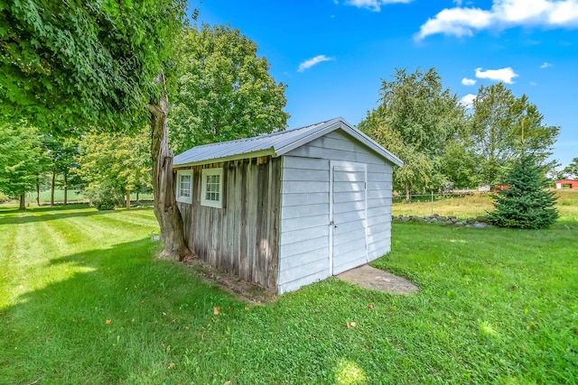 view of outbuilding featuring a yard